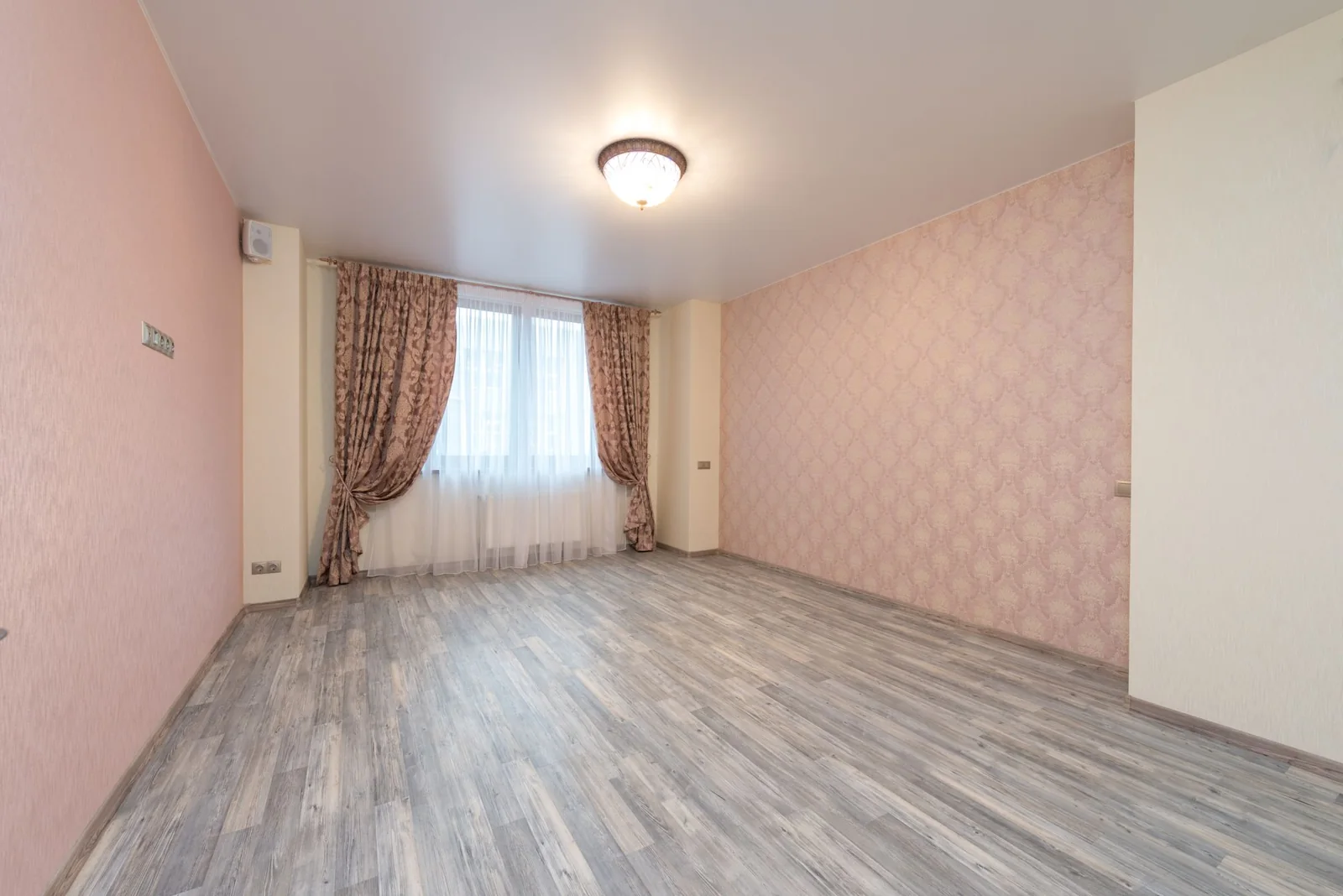 Unfurnished room with timber floor and curtained window